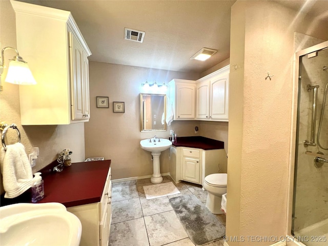 1403 NW Mimosa Cir, Stigler, OK 74462 - full bathroom with a shower stall, toilet, tile patterned flooring, and baseboards