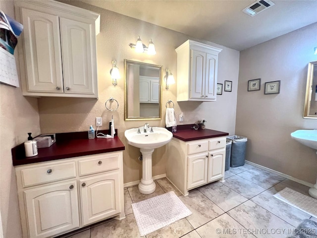 1403 NW Mimosa Cir, Stigler, OK 74462 - bathroom with baseboards, tile patterned floors, and a sink