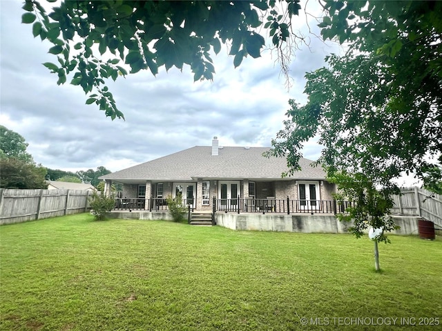 1403 NW Mimosa Cir, Stigler, OK 74462 - rear view of house with french doors and a chimney
