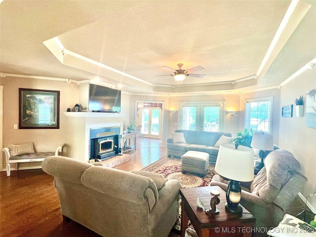 1403 NW Mimosa Cir, Stigler, OK 74462 - living area with a raised ceiling, wood finished floors, a textured ceiling, crown molding, and ceiling fan