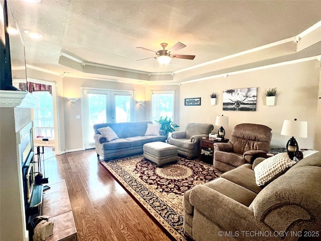 1403 NW Mimosa Cir, Stigler, OK 74462 - living room with ornamental molding, a raised ceiling, ceiling fan, a textured ceiling, and wood finished floors