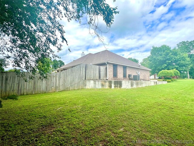 1403 NW Mimosa Cir, Stigler, OK 74462 - back of property featuring central AC and brick siding