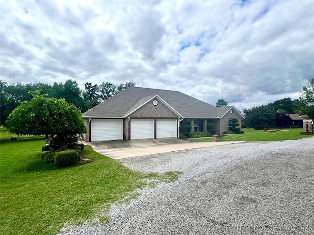 1403 NW Mimosa Cir, Stigler, OK 74462 - view of front of property featuring concrete driveway, an attached garage, a front lawn, and brick siding