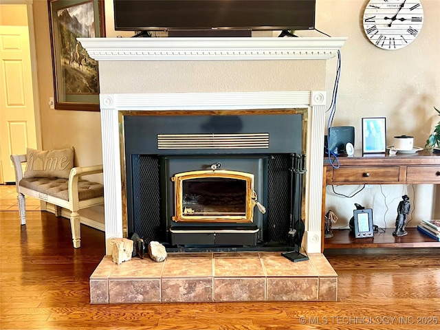 1403 NW Mimosa Cir, Stigler, OK 74462 - detailed view of wood finished floors, a tile fireplace, and baseboards