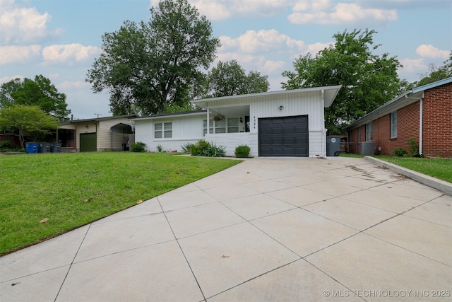 4524 E 45th St, Tulsa, OK 74135 - view of front of property with an attached garage, brick siding, a front lawn, and concrete driveway