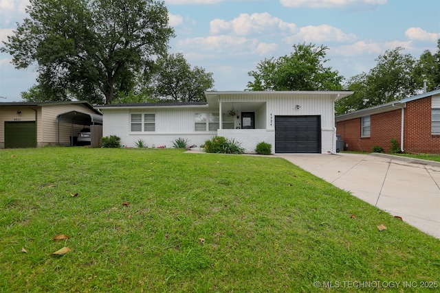 4524 E 45th St, Tulsa, OK 74135 - view of front of property with brick siding, an attached garage, a front lawn, and driveway