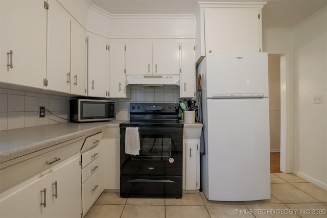 4524 E 45th St, Tulsa, OK 74135 - kitchen featuring freestanding refrigerator, black range with electric cooktop, under cabinet range hood, stainless steel microwave, and backsplash