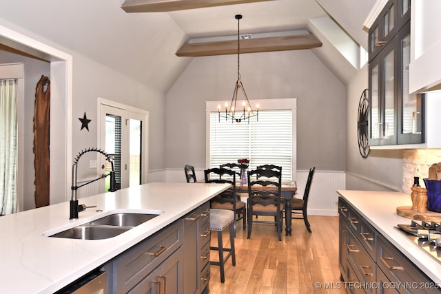 10434 S 218th E Ave, Broken Arrow, OK 74014 - kitchen with a sink, light wood-style flooring, vaulted ceiling, hanging light fixtures, and wainscoting