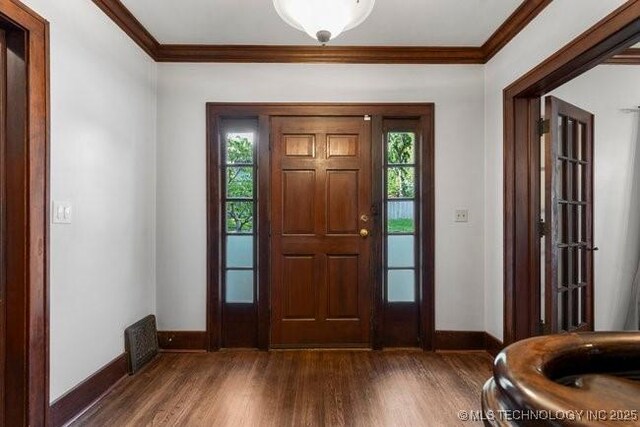 1701 S Rockford Ave, Tulsa, OK 74120 - entryway featuring baseboards, crown molding, and wood finished floors