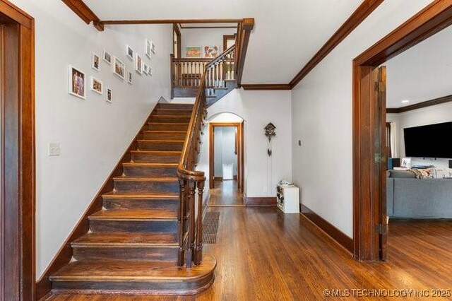1701 S Rockford Ave, Tulsa, OK 74120 - stairs featuring crown molding, wood finished floors, and baseboards