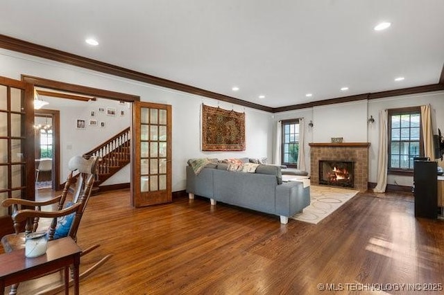1701 S Rockford Ave, Tulsa, OK 74120 - living area with crown molding, wood finished floors, french doors, a fireplace, and stairway