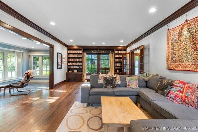 1701 S Rockford Ave, Tulsa, OK 74120 - living area with ornamental molding, wood finished floors, recessed lighting, built in shelves, and baseboards