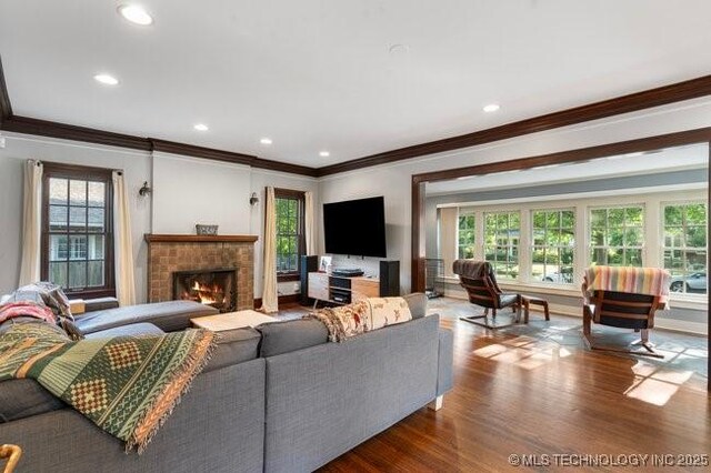 1701 S Rockford Ave, Tulsa, OK 74120 - living room with ornamental molding, a lit fireplace, wood finished floors, and recessed lighting