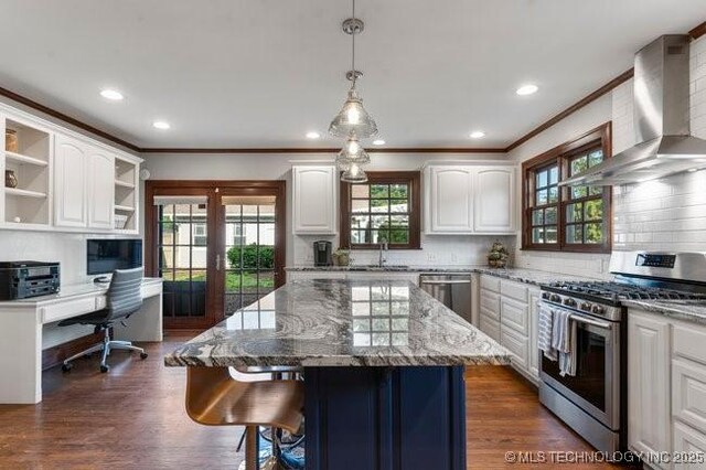 1701 S Rockford Ave, Tulsa, OK 74120 - kitchen with stainless steel appliances, wall chimney exhaust hood, crown molding, a sink, and open shelves