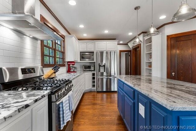 1701 S Rockford Ave, Tulsa, OK 74120 - kitchen with appliances with stainless steel finishes, wall chimney exhaust hood, blue cabinetry, white cabinetry, and recessed lighting