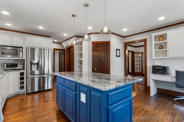 1701 S Rockford Ave, Tulsa, OK 74120 - kitchen with appliances with stainless steel finishes, blue cabinetry, ornamental molding, white cabinets, and recessed lighting