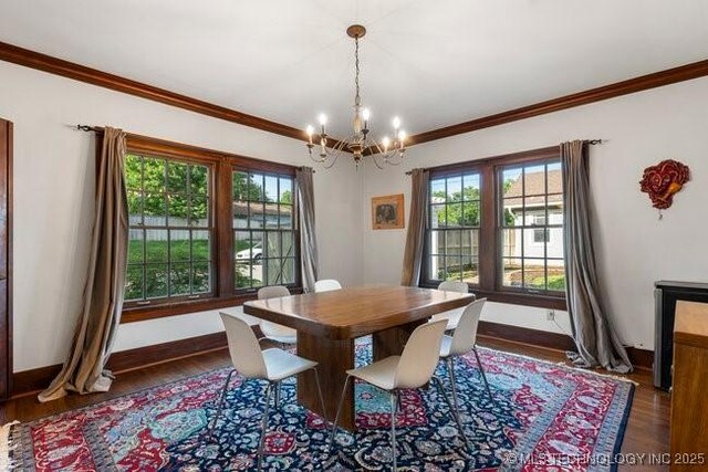 1701 S Rockford Ave, Tulsa, OK 74120 - dining space with a chandelier, healthy amount of natural light, wood finished floors, and crown molding