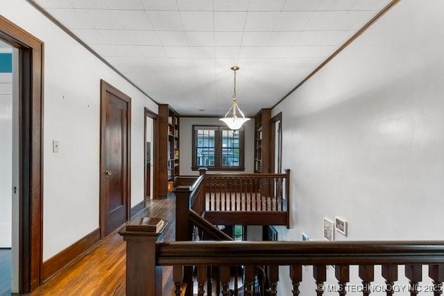 1701 S Rockford Ave, Tulsa, OK 74120 - hallway featuring wood finished floors, an upstairs landing, and baseboards