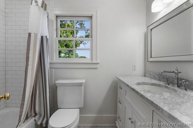 1701 S Rockford Ave, Tulsa, OK 74120 - full bathroom featuring vanity, toilet, shower / tub combo with curtain, and baseboards