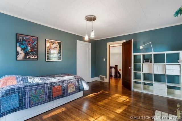 1701 S Rockford Ave, Tulsa, OK 74120 - bedroom with crown molding, wood finished floors, and baseboards
