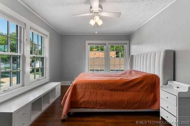 1701 S Rockford Ave, Tulsa, OK 74120 - bedroom with wood finished floors, ornamental molding, a ceiling fan, and a textured ceiling