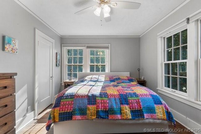 1701 S Rockford Ave, Tulsa, OK 74120 - bedroom with ornamental molding, wood finished floors, and a ceiling fan
