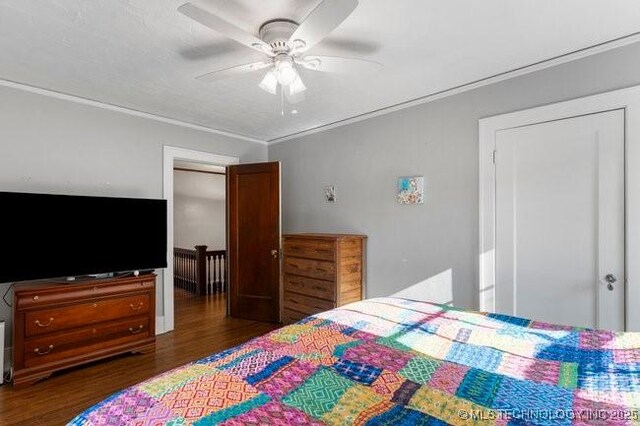 1701 S Rockford Ave, Tulsa, OK 74120 - bedroom with wood finished floors, crown molding, and a ceiling fan