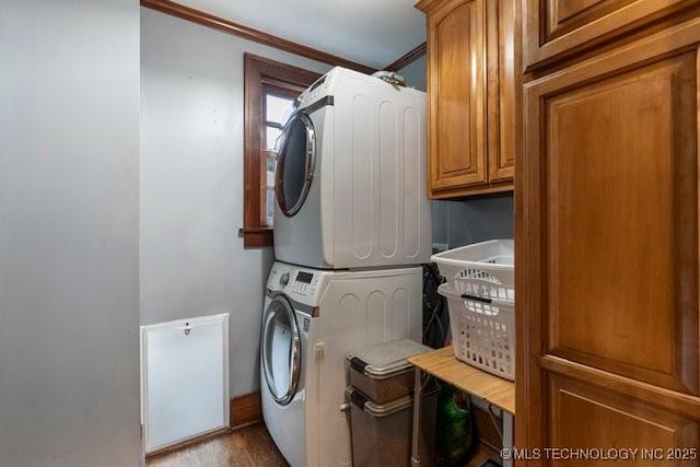 1701 S Rockford Ave, Tulsa, OK 74120 - laundry room featuring estacked washer and dryer, ornamental molding, cabinet space, and wood finished floors