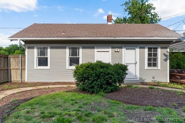 1701 S Rockford Ave, Tulsa, OK 74120 - rear view of house featuring a chimney and a shingled roof