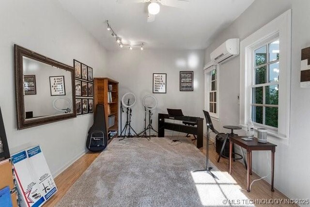 1701 S Rockford Ave, Tulsa, OK 74120 - home office featuring a wall mounted air conditioner, wood finished floors, ceiling fan, and baseboards