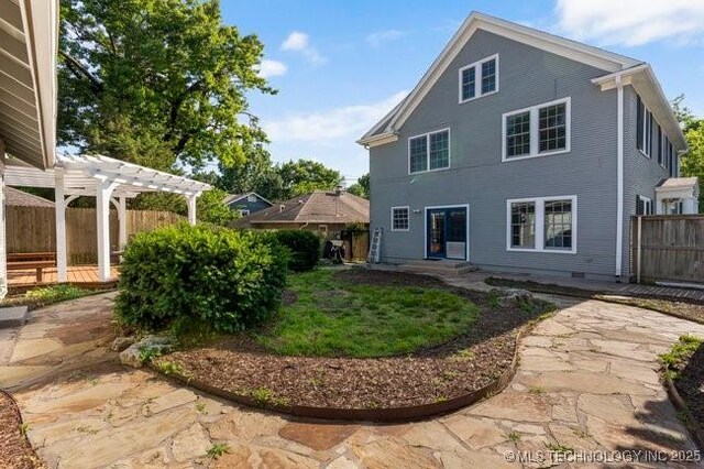 1701 S Rockford Ave, Tulsa, OK 74120 - back of house featuring a pergola, a fenced backyard, and a patio