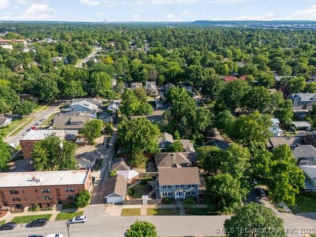 1701 S Rockford Ave, Tulsa, OK 74120 - aerial overview of property's location with nearby suburban area and a forest