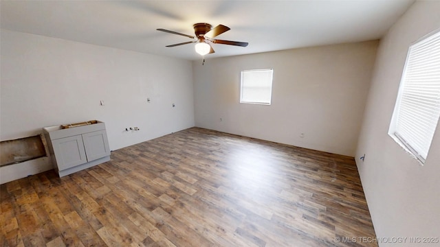 unfurnished room with a ceiling fan and wood finished floors