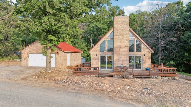 750 Spavinaw Hudson Pt, Spavinaw, OK 74366 - view of front of property featuring a chimney, a wooden deck, an outbuilding, and a garage