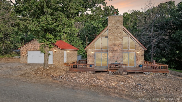 750 Spavinaw Hudson Pt, Spavinaw, OK 74366 - view of front of house with a chimney, a wooden deck, an outdoor structure, and brick siding
