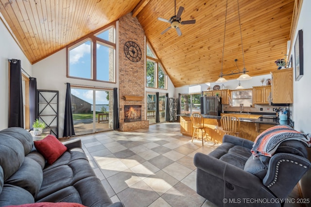 750 Spavinaw Hudson Pt, Spavinaw, OK 74366 - living room featuring high vaulted ceiling, wooden ceiling, a ceiling fan, light tile patterned flooring, and a fireplace