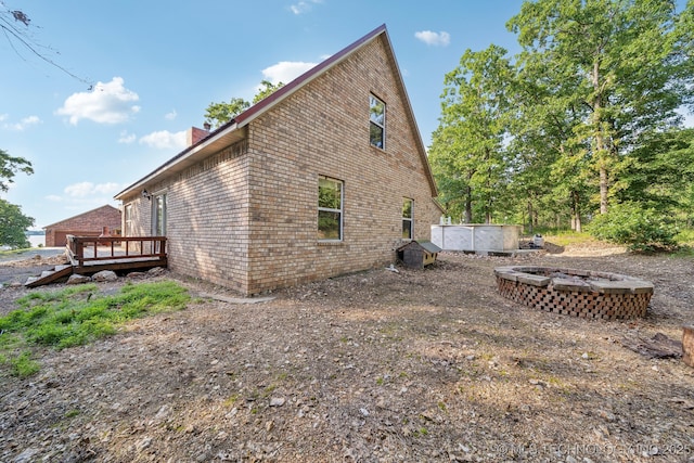 750 Spavinaw Hudson Pt, Spavinaw, OK 74366 - view of side of property featuring a wooden deck, a chimney, and brick siding