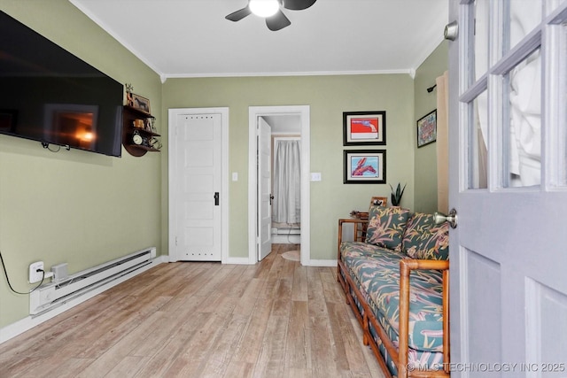 1241 E 29th St, Tulsa, OK 74114 - sitting room featuring baseboard heating, crown molding, a ceiling fan, and wood finished floors