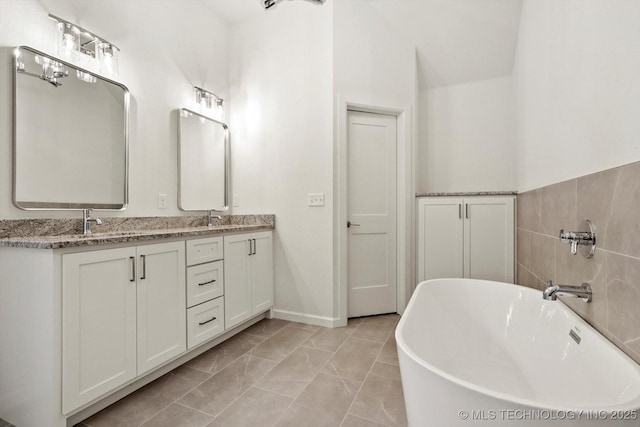 6512 N 27th St, Broken Arrow, OK 74014 - full bathroom featuring a freestanding bath, double vanity, and marble look tile flooring