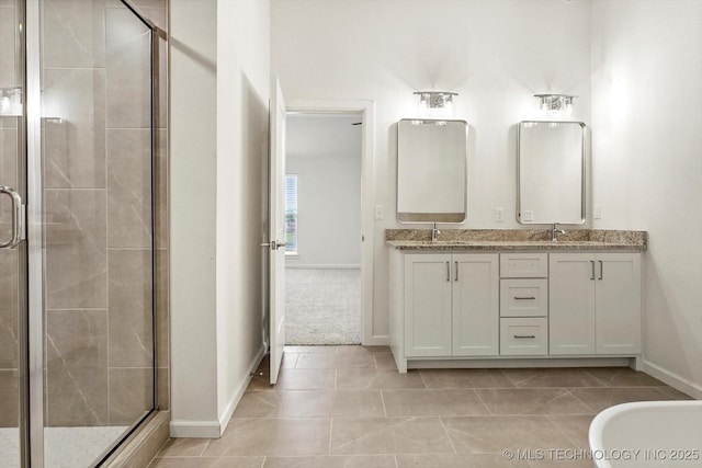 6512 N 27th St, Broken Arrow, OK 74014 - full bath featuring a stall shower, double vanity, baseboards, and tile patterned floors