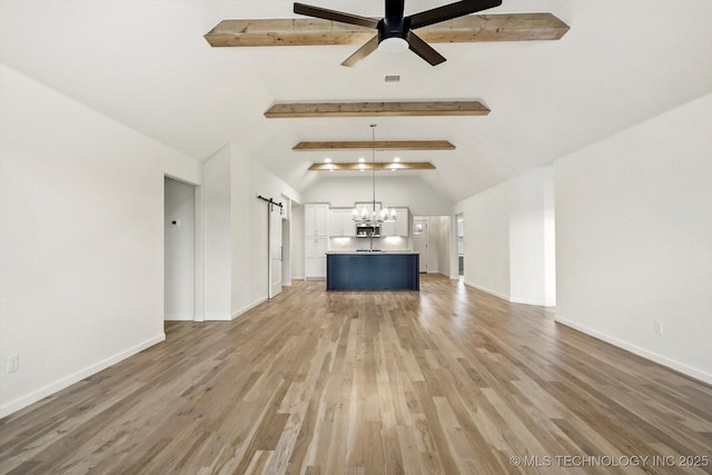 6512 N 27th St, Broken Arrow, OK 74014 - unfurnished living room featuring a barn door, light wood-type flooring, a ceiling fan, a chandelier, and baseboards