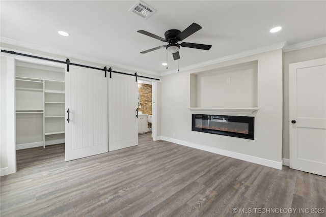4526 W Broadway St, Muskogee, OK 74401 - unfurnished bedroom with a barn door, crown molding, wood finished floors, recessed lighting, and baseboards