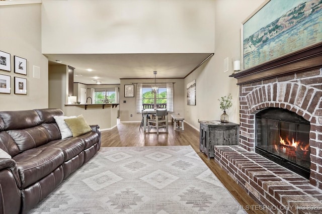 14355 N Trenton Ave, Skiatook, OK 74070 - living area with a towering ceiling, wood finished floors, and a brick fireplace