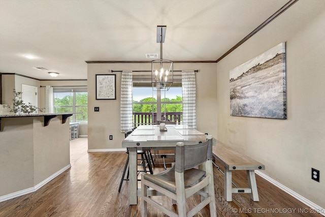 14355 N Trenton Ave, Skiatook, OK 74070 - dining space featuring wood finished floors, crown molding, and a chandelier