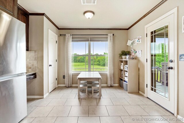 14355 N Trenton Ave, Skiatook, OK 74070 - dining room with ornamental molding and light tile patterned floors