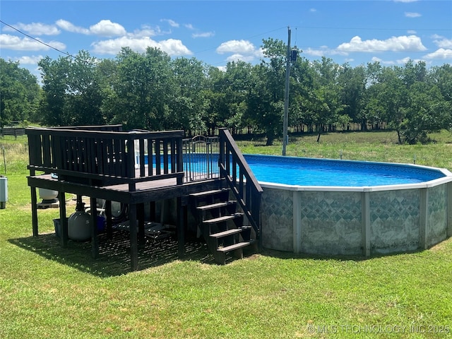 14355 N Trenton Ave, Skiatook, OK 74070 - outdoor pool with a yard, a deck, and view of wooded area