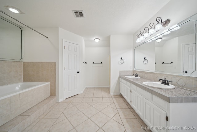 9227 S 95th E Ave, Tulsa, OK 74133 - bathroom featuring double vanity, tile patterned flooring, tiled bath, and baseboards