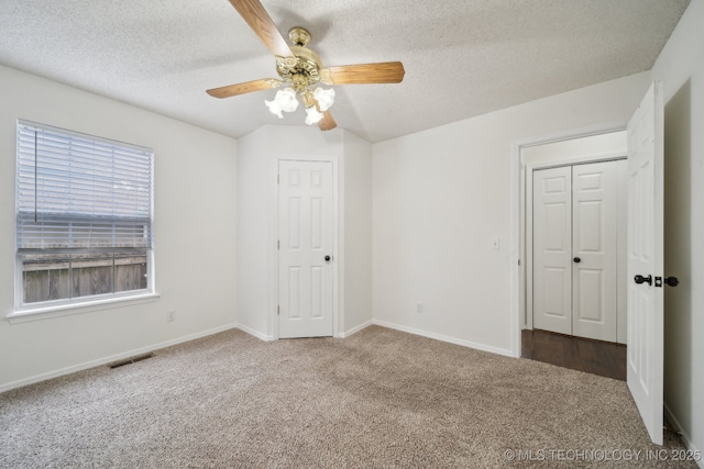 9227 S 95th E Ave, Tulsa, OK 74133 - unfurnished bedroom with carpet flooring, a textured ceiling, baseboards, and a ceiling fan