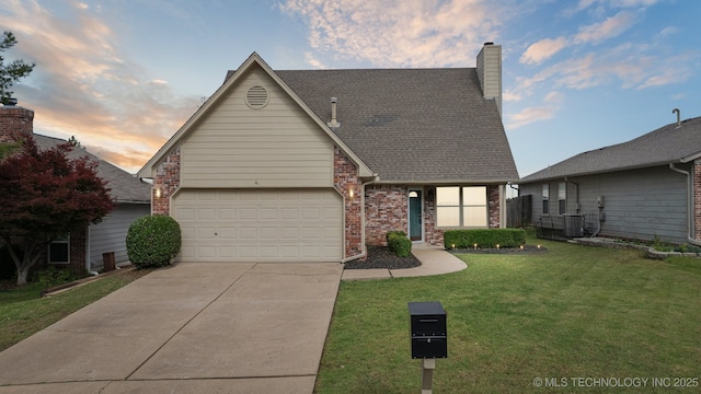 9227 S 95th E Ave, Tulsa, OK 74133 - traditional-style home with concrete driveway, cooling unit, a front yard, a chimney, and a garage