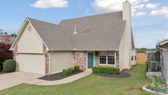9227 S 95th E Ave, Tulsa, OK 74133 - view of front facade featuring a chimney, a shingled roof, driveway, and brick siding